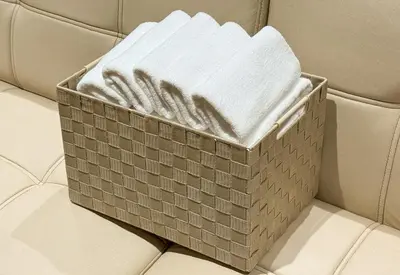 a box of folded towels sitting on a couch at GInza6-7F in Tokyo
