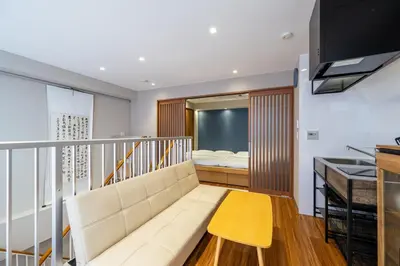 a living room with a couch and a bed at GInza6-7F in Tokyo