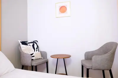 two chairs and a table next to a bed at Yoyogi New Flats - Vacation STAY 20252 in Tokyo