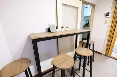 a bar in a room with four stools at Yoyogi New Flats - Vacation STAY 20252 in Tokyo