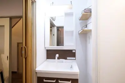 a bathroom with a white sink and a mirror at Yoyogi New Flats - Vacation STAY 20252 in Tokyo
