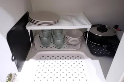 a small refrigerator with dishes and plates in it at Yoyogi New Flats - Vacation STAY 20252 in Tokyo