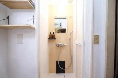 a bathroom with a shower in the corner of a room at Yoyogi New Flats - Vacation STAY 20252 in Tokyo