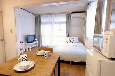a small room with a bed and a table with dishes on it at Yoyogi New Flats - Vacation STAY 20254 in Tokyo