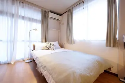 a bedroom with a bed and a large window at Yoyogi New Flats - Vacation STAY 20254 in Tokyo
