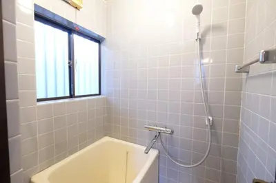 a bathroom with a bath tub and a window at Yoyogi New Flats - Vacation STAY 20254 in Tokyo