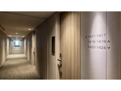 a hallway with a long corridor with writing on the door at Far East Village Hotel Tokyo Ariake - Vacation STAY 44125v in Tokyo