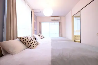 a bedroom with two beds and a window at Belshaart Kamikitazawa - Vacation STAY 20236 in Tokyo