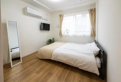 a bedroom with a bed and a mirror in it at Repure Omori Residence 402 - Vacation STAY 20222 in Tokyo