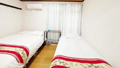 two beds in a room with a window at Espoir - Vacation STAY 42536v in Tokyo