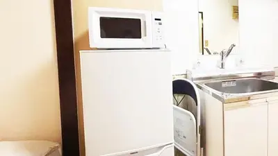 a microwave on top of a refrigerator in a kitchen at Espoir - Vacation STAY 42513v in Tokyo