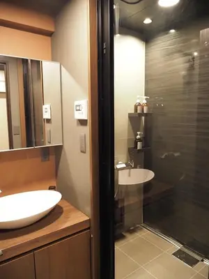a bathroom with two sinks and a glass shower at T-home\u6953 T-home Fu in Tokyo