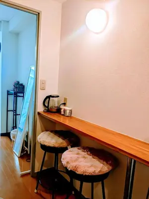 a room with a counter with two stools under it at Cozy Stay Ebisu in Tokyo