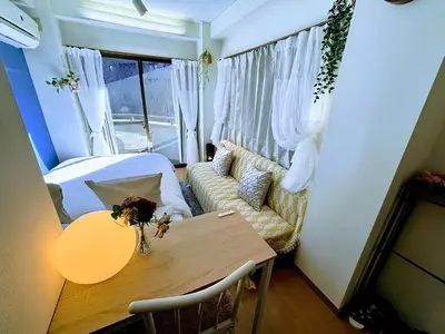 a small living room with a table and a couch at Cozy Stay Ebisu in Tokyo