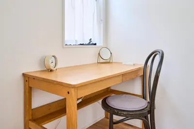 a wooden desk with a chair and a mirror at EK Stay Tenku-no-ki \u5929\u7a7a\u306e\u6a39 Asakusa SkyTree Area 4BR Chic House Near Station in Tokyo