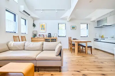 a living room and kitchen with a couch and a table at EK Stay Tenku-no-ki \u5929\u7a7a\u306e\u6a39 Asakusa SkyTree Area 4BR Chic House Near Station in Tokyo