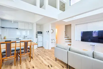 a kitchen and living room with a couch and a table at EK Stay Tenku-no-ki \u5929\u7a7a\u306e\u6a39 Asakusa SkyTree Area 4BR Chic House Near Station in Tokyo