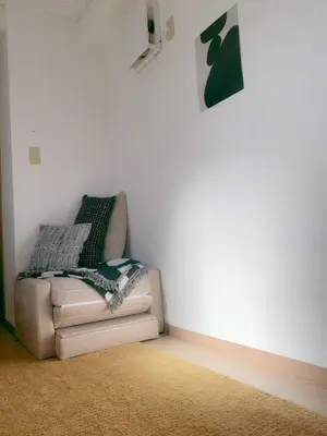 a couch sitting in a corner of a room at Homestay in hiroo in Tokyo