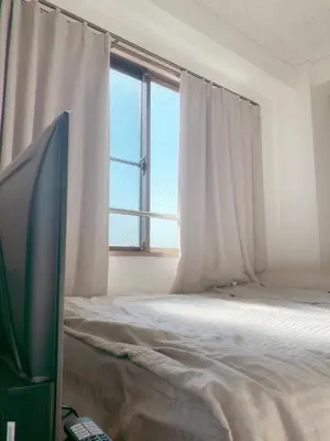 a bedroom with a bed and a tv and a window at Homestay in hiroo in Tokyo