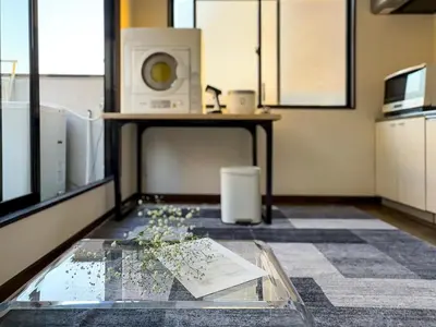 a room with a glass table and a microwave at Mando Hotel \u6b65\u884c\u81f3 Asakusa Ueno in Tokyo