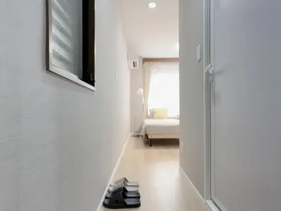 a pair of shoes are sitting on the floor of a hallway at Mando Hotel \u6b65\u884c\u81f3 Asakusa Ueno in Tokyo