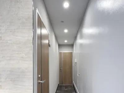 a hallway with a wooden door and a wall at Mando Hotel \u6b65\u884c\u81f3 Asakusa Ueno in Tokyo
