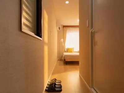 a hallway with shoes on the floor of a room at Mando Hotel \u6b65\u884c\u81f3 Asakusa Ueno in Tokyo