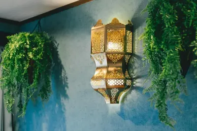 a light hanging on a wall with plants at Otter Stay - Ikebukuro in Tokyo