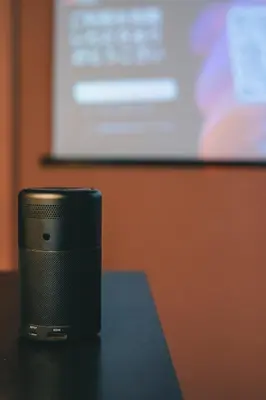 a speaker sitting on a table in front of a screen at Otter Stay - Ikebukuro in Tokyo