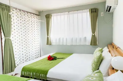 a bedroom with a white bed and a window at Room 303, a 6-minute walk from Tokyo Koiwa Station Direct connected to Shinjuku and Akihabara Stations Comfortable one-bedroom apartment with separate wet and dry areas in Tokyo