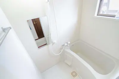 a white bathroom with a tub and a mirror at Room 303, a 6-minute walk from Tokyo Koiwa Station Direct connected to Shinjuku and Akihabara Stations Comfortable one-bedroom apartment with separate wet and dry areas in Tokyo