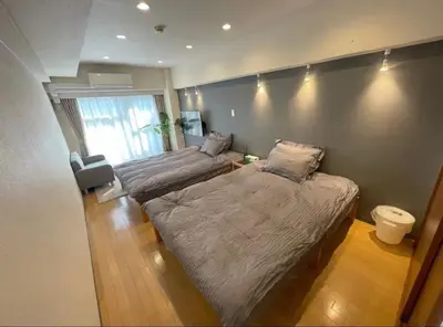 a bedroom with two beds and a large window at yuki shinjuku okubo 5F 502-SJ0044 in Tokyo