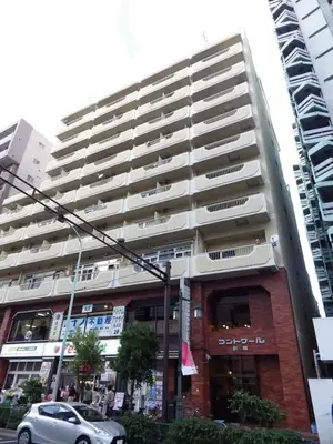 a large apartment building with a car parked in front of it at yuki shinjuku okubo 5F 502-SJ0044 in Tokyo
