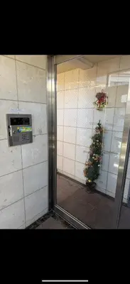 a glass door of a building with a christmas tree at \u685c\u306e\u5c4b25\u5e73\u65b9\u5927\u5e8a\u623fSakura House 25 square meter king size bed room202 in Tokyo