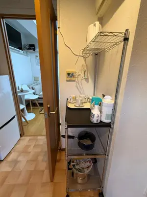 a kitchen with a cart in the corner of a room at \u685c\u306e\u5c4b25\u5e73\u65b9\u5927\u5e8a\u623fSakura House 25 square meter king size bed room202 in Tokyo