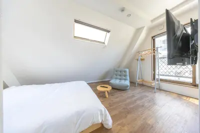 a bedroom with a bed and a flat screen tv at The best Nakano house 4 minutes to station in Tokyo