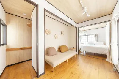 a bedroom with a couch and a bed in a room at A unique cozy townhouse perfect for up to 5 guests in Tokyo