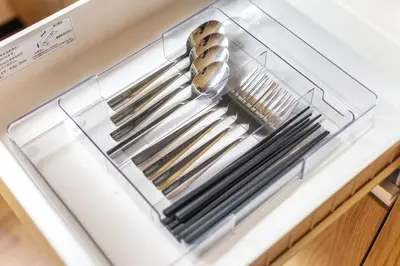 a stack of silver utensils in a clear container at A unique cozy townhouse perfect for up to 5 guests in Tokyo