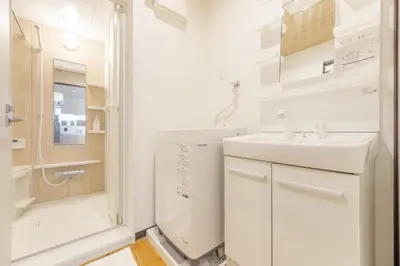 a white bathroom with a sink and a shower at A unique cozy townhouse perfect for up to 5 guests in Tokyo