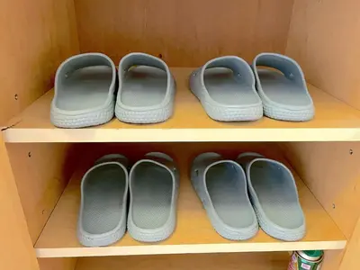 four pairs of shoes on a shelf in a closet at Shinjyuku Kabukisho vacation stay self check in in Tokyo