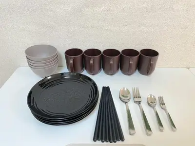 a table with a black plate and forks and spoons at Shinjyuku Kabukisho vacation stay self check in in Tokyo
