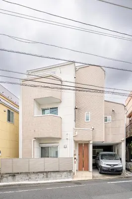 a building with a car parked in front of it at Familia Kamata 2 in Tokyo