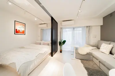 a bedroom with a bed and a couch at Brand New Apt near Roppongi 4min Walk in Tokyo