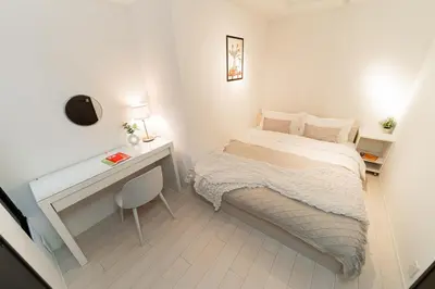 a small bedroom with a bed and a desk at Brand New Apt near Roppongi 4min Walk in Tokyo