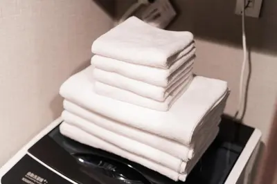 a stack of towels stacked on top of a toaster at Brand New Apt near Roppongi 4min Walk in Tokyo
