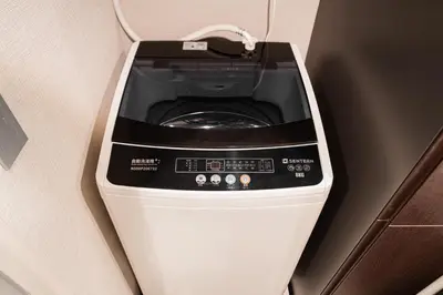 a washer and dryer in the corner of a room at Brand New Apt near Roppongi 4min Walk in Tokyo