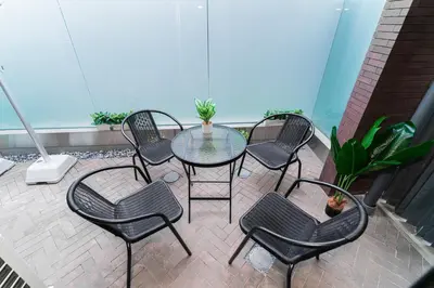 a patio with a table and chairs on a balcony at Brand New Apt near Roppongi 4min Walk in Tokyo
