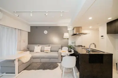 a kitchen and a living room with a couch at Brand New Apt near Roppongi 4min Walk in Tokyo