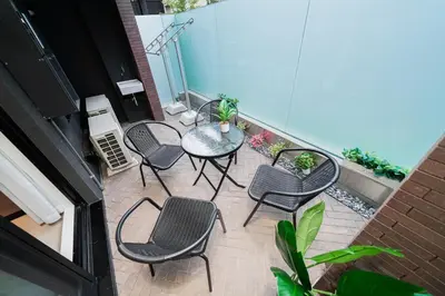 a patio with chairs and a table on a balcony at Brand New Apt near Roppongi 4min Walk in Tokyo