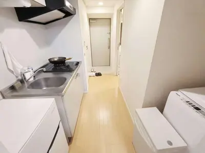 a small kitchen with a sink and a stove at \u6c60\u888b\u4e2d\u5fc3\u5730\u5e26! \u6c60\u888b\u8f66\u7ad9\u6b65\u884c6\u5206! \u516c\u5bd3\u5e72\u6e7f\u5206\u79bb!\u667a\u80fd\u9a6c\u6876! \u9ad8\u901f\u65e0\u9650\u5236\u7f51\u8def!Ikebukuro Center! Ikebukuro 6min walk!oioi201 in Tokyo